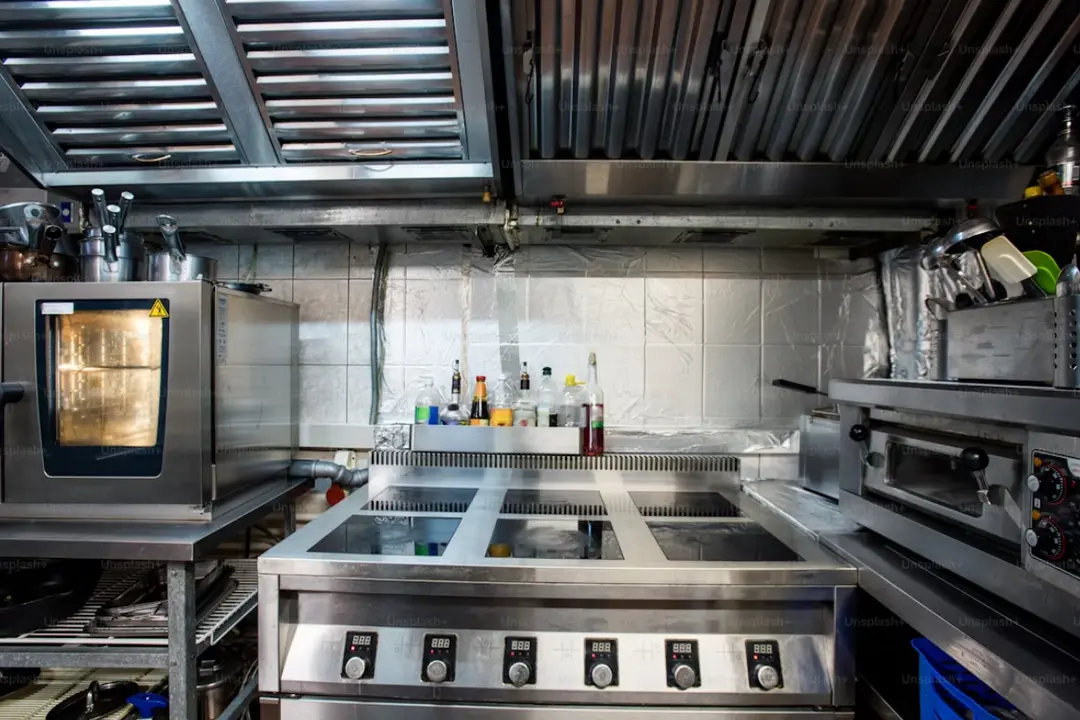 Modern commercial kitchen with stainless steel equipment, ideal for illustrating how to secure a commercial kitchen lease.
